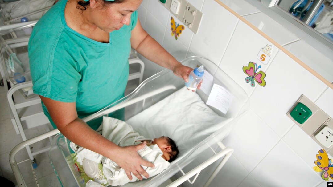 FILE - A nurse bottle feeds a newborn baby at a maternity ward of the University Hospital in Tegucigalpa, Honduras, July 26, 2016.
