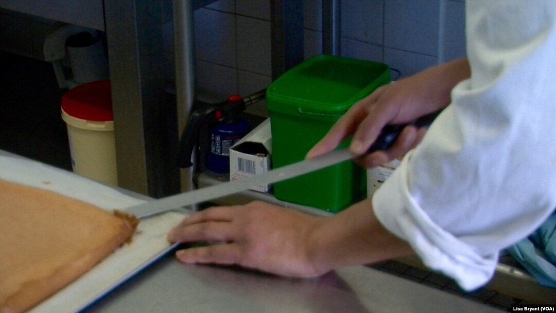 Inmate William prepares to spread cream on a lemon spongecake.
