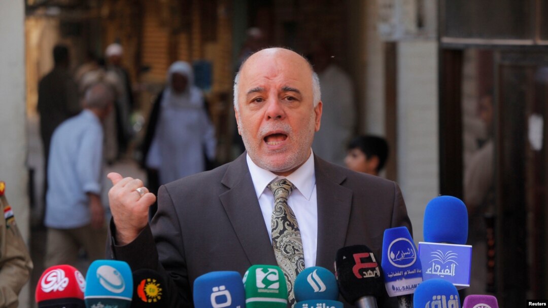 FILE - Iraqi Prime Minister Haider al-Abadi speaks to reporters in the Shi'ite holy city of Najaf, south of Baghdad.