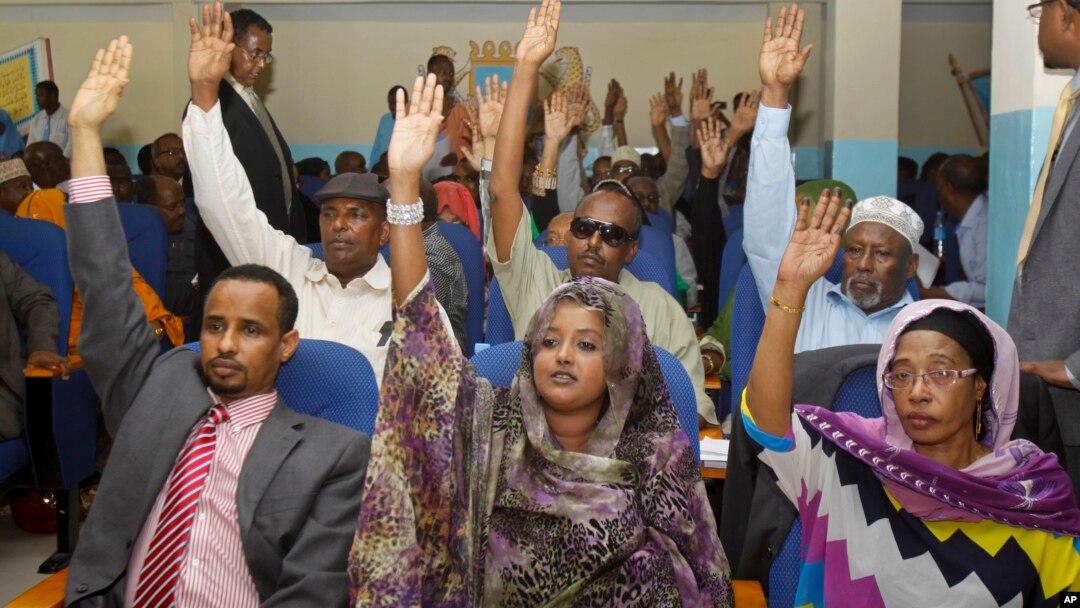 Somalia lawmakers raise their hands during a confidence vote on Prime Minister Abdiweli Sheikh Ahmed, at the Parliament Building in Mogadishu, Somalia, Dec. 6, 2014.