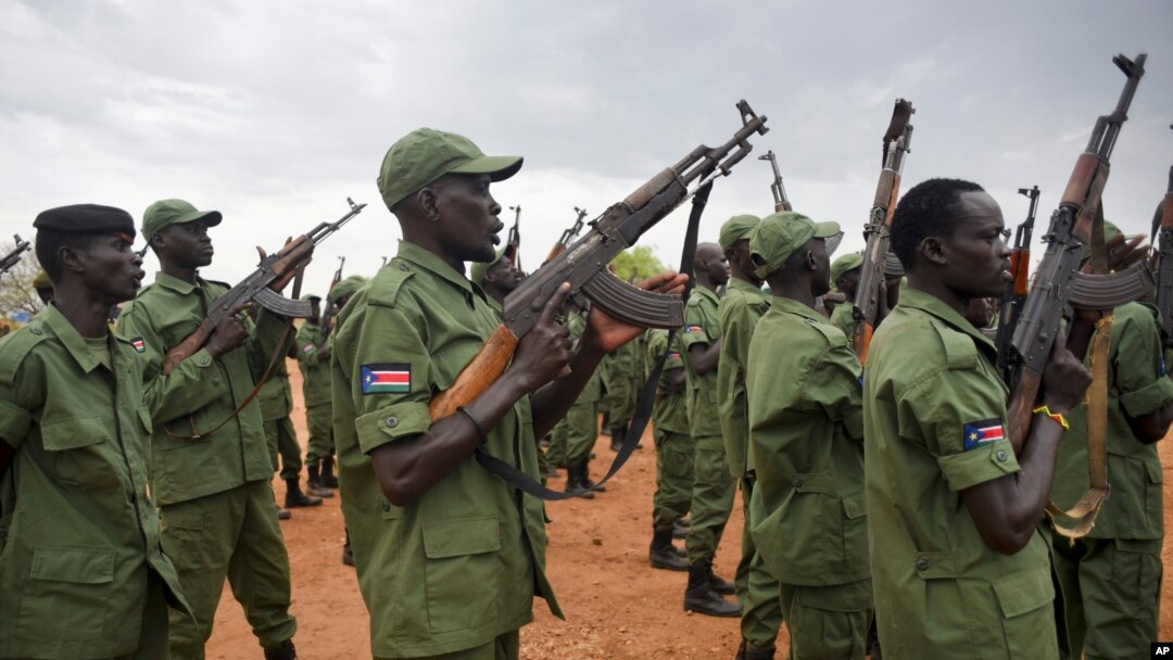 FILE - South Sudanese rebel soldiers raise their weapons at a military camp in the capital, Juba, South Sudan, April 7, 2016.