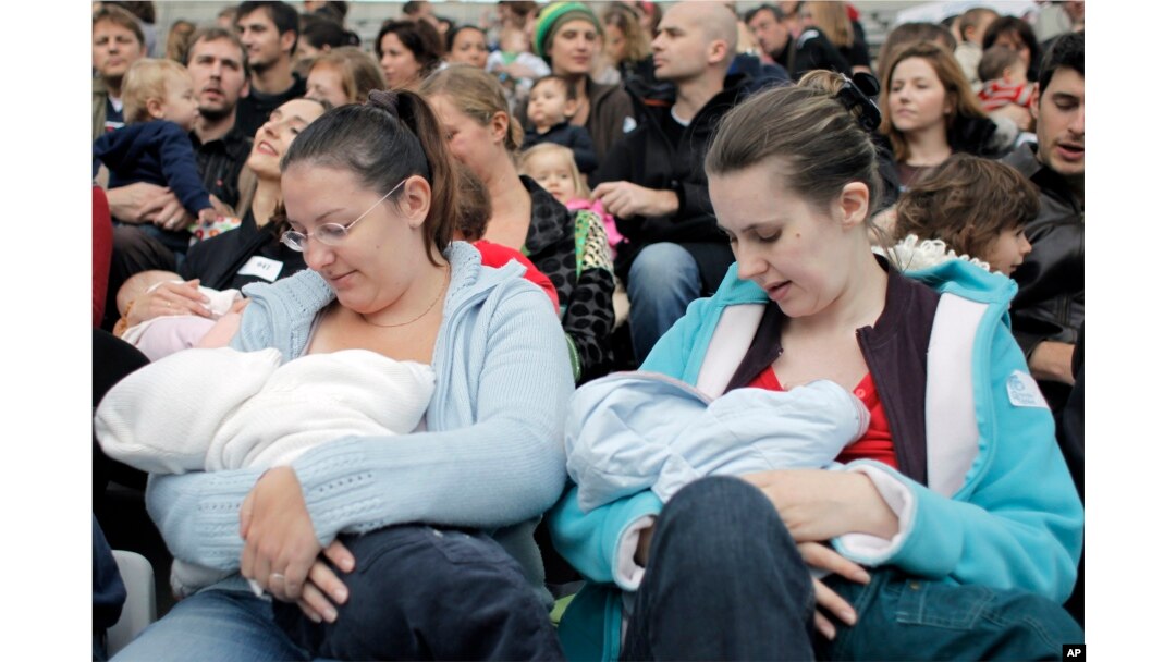 FILE - Mothers breast-feed their babies in Paris, Oct. 11, 2008, during a worldwide breast-feeding event.