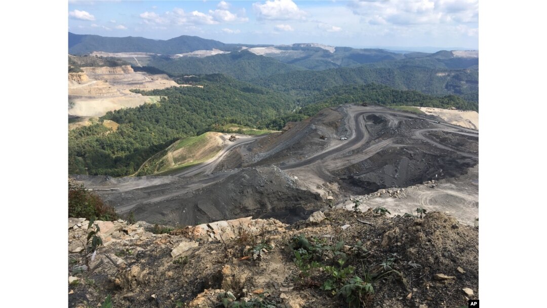 FILE - Coal trucks and heavy equipment are seen on the Middle Ridge surface coal mine in southern West Virginia, Sept. 26, 2017.