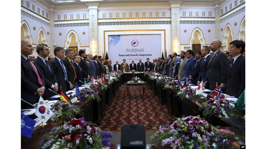 FILE - Afghan President Ashraf Ghani (C) and delegates stand for the national anthem during the Kabul Process conference, at the Presidential Palace in Kabul, Afghanistan, June 6, 2017.