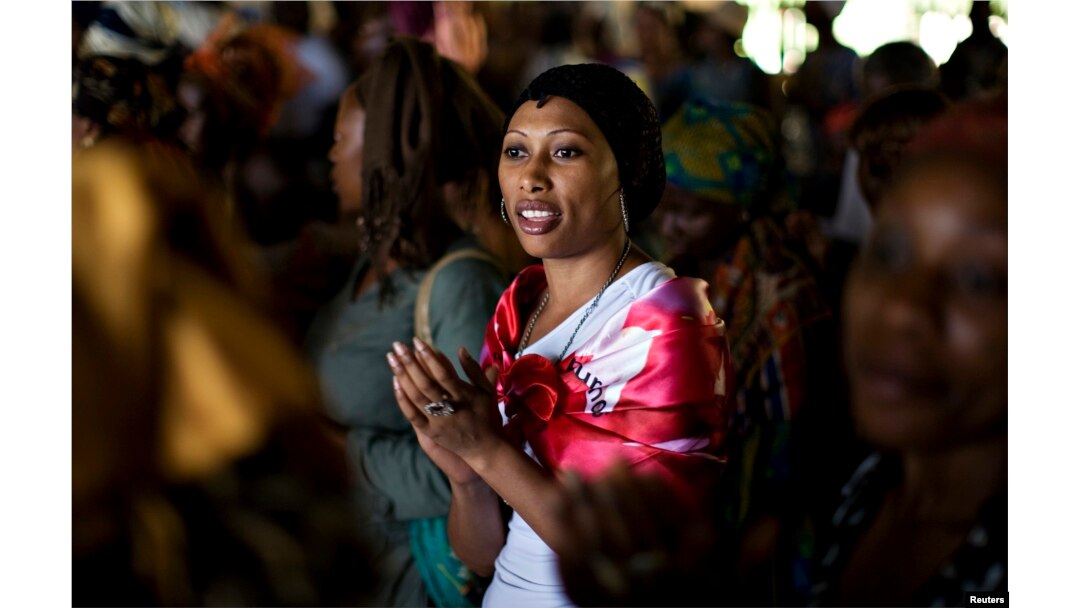 FILE - A woman sings during a prayer session at the Saint Francis Xavier parish, part of the fraternity Ephphata charismatic awakening branch of the Catholic church, ahead of the arrival on Tuesday of Pope Benedict XVI in Yaounde March 17, 2009.