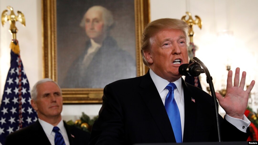 U.S. Vice President Mike Pence listens as U.S. President Donald Trump announces that the United States recognizes Jerusalem as the capital of Israel and will move its embassy there, during an address from the White House, Dec. 6, 2017.