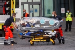FILE - German army emergency personnel load into their ambulance the stretcher that was used to transport Russian opposition figure Alexei Navalny on at Berlin's Charite hospital, August 22, 2020.