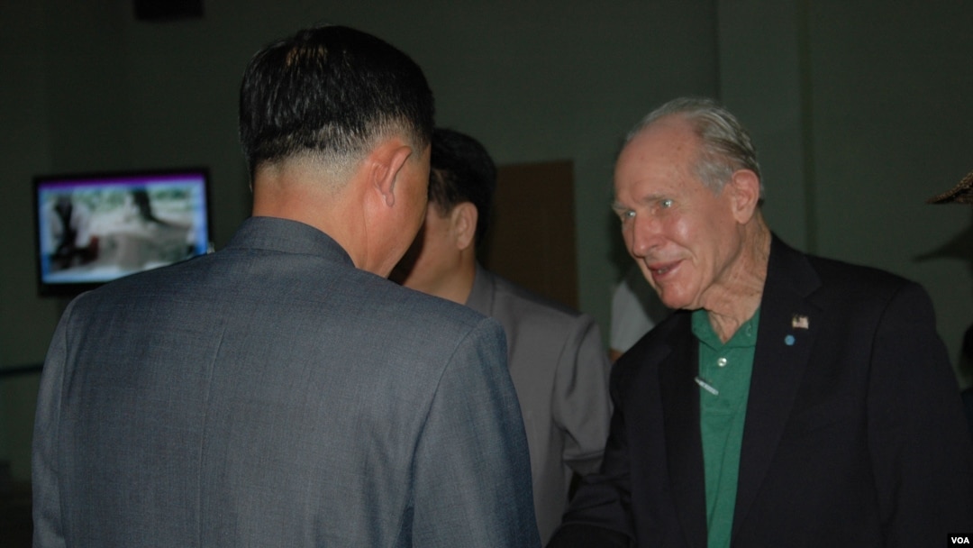 Former US Navy pilot and medal of honor recipient Thomas Hudner, seen here arriving at Pyongyang airport July 20, 2013, is greeted by North Korean officials. (VOA/S. Herman)