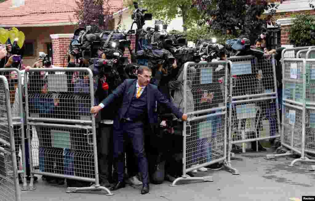 A security official holds barriers during the arrival of Saudi officials at Saudi Arabia's consulate in Istanbul, Turkey.