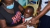 Jeywellan Ochieng, 2, reacts after receiving the vaccine against malaria as she is held by her mother, Julliet Achieng, at the Yala Sub County Hospital Mother and Child Healthcare (MCH) clinic in Gem, Siaya County, Kenya, October 7, 2021. 