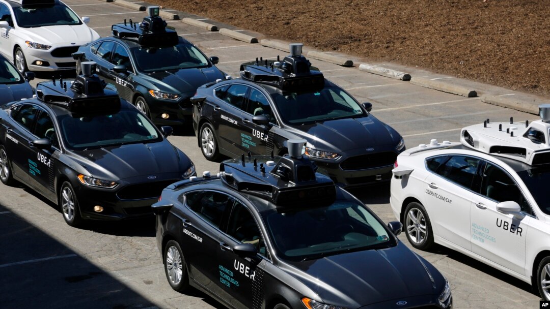 A group of self-driving Uber vehicles position themselves to take journalists on rides during a media preview at Uber's Advanced Technologies Center in Pittsburgh, Pennsylvania, Sept. 12, 2016.