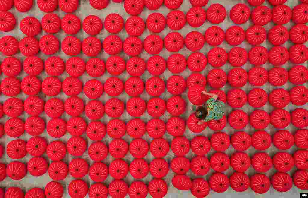 A worker produces red lanterns ahead of China's National Day in Danzhai, southwestern Guizhou province.