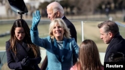 Jill Biden waves after her husband, Joe, is sworn-in as the 46th U.S. president at the U.S. Capitol in Washington, January 20, 2021.
