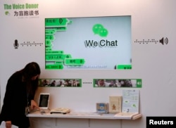 FILE - A counter promoting WeChat, a product of Tencent, on reading books for the blind, is displayed at a news conference announcing the company's results in Hong Kong, March 18, 2015.