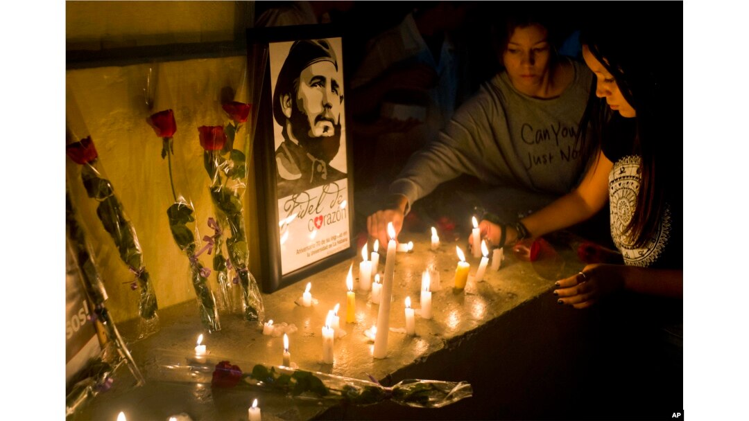 Students place candles around an image of the late Cuban leader Fidel Castro, at the university where Castro studied law as a young man, during a vigil in Havana, Cuba, Nov. 26, 2016.