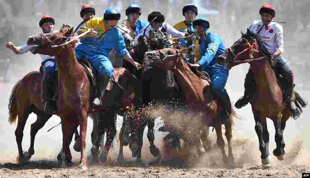 Russian (white) and Kazakh (blue) riders play the traditional Central Asian sport Buzkashi also known as Kok-Boru or Oglak Tartis during the World Nomad Games 2018 in Cholpon-Ata, eastern Kirghizstan.
