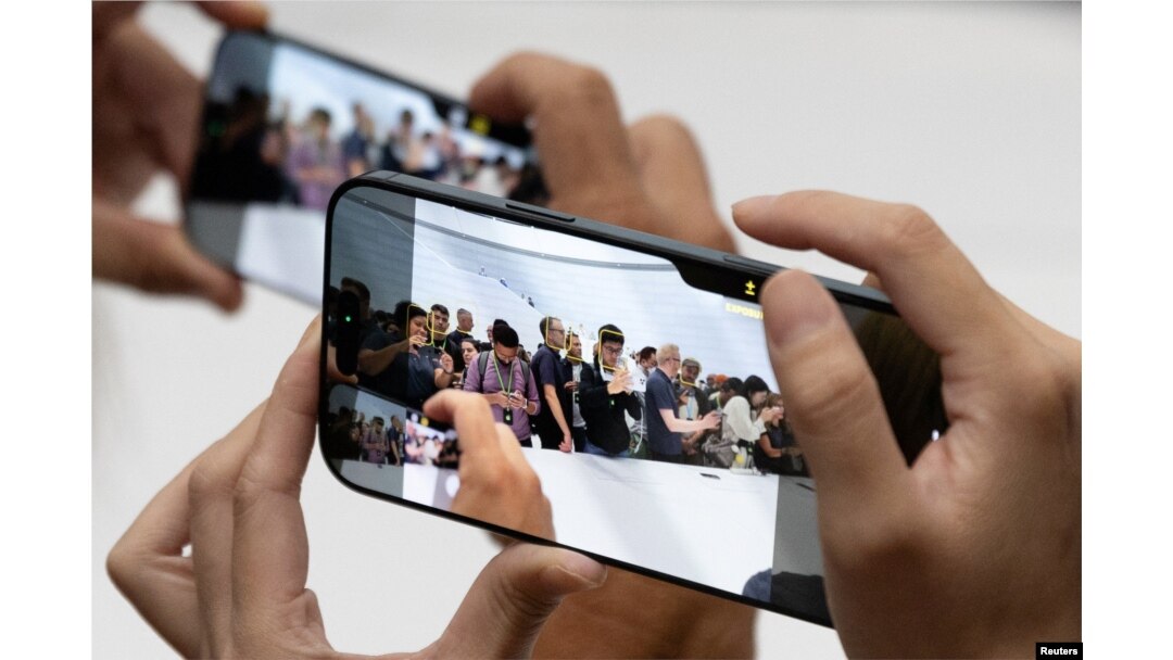 Attendees try the new iPhone 16 as Apple holds an event at the Steve Jobs Theater on its campus in Cupertino, California, on Sept. 9, 2024.