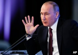 FILE - Russian President Vladimir Putin gestures during his annual news conference in Moscow, Russia, Dec. 23, 2016.