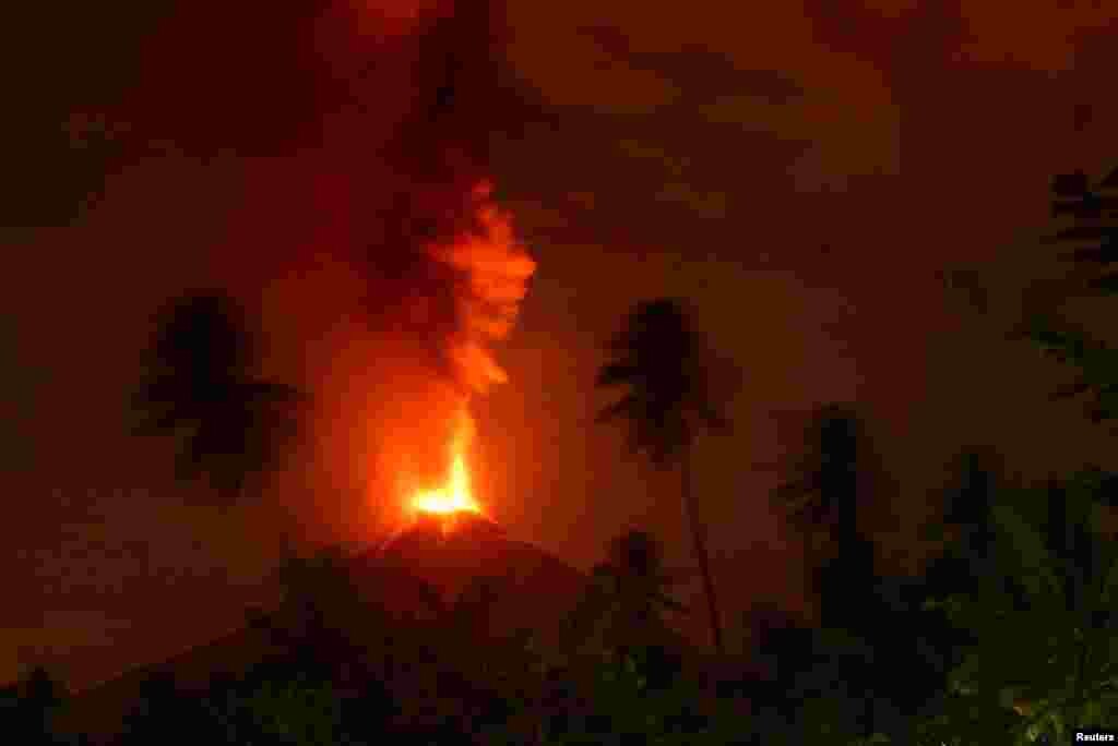 Mount Soputan volcano erupts on October 3, as seen from Lobu village in Southeast Minahasa regency, North Sulawesi, Indonesia.