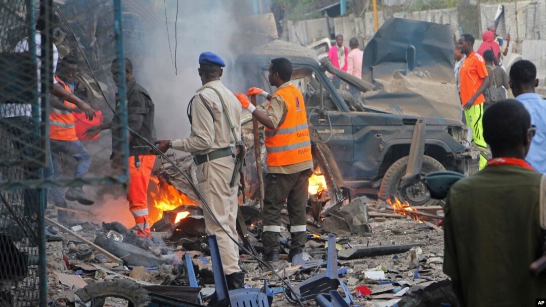 FILE - Somali soldier inspect wreckage of vehicles after a car bomb that was detonated in Mogadishu, Oct 28, 2017. 