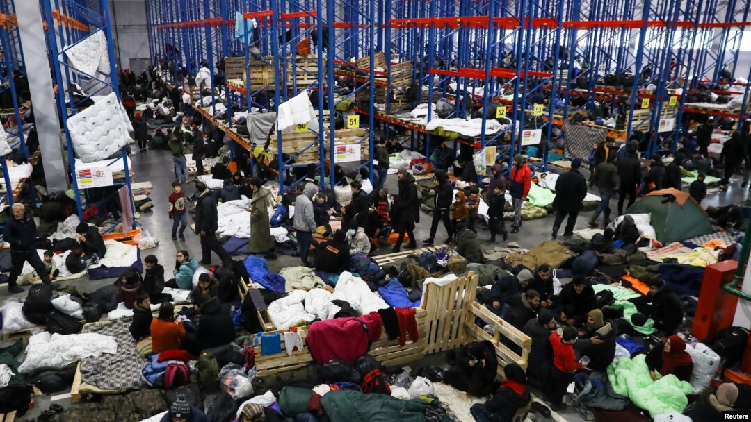 Migrants gather at a transport and logistics center near the Belarusian-Polish border in the Grodno region, Belarus, Belarus, Nov. 19, 2021. 