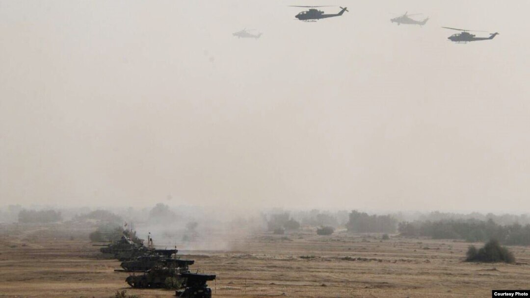 FILE - Pakistan's army tanks and helicopters, seen in this army-issued photo, take part in a military exercise in Khairpur Tamiwali, Pakistan.