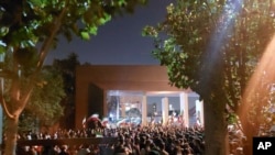 This photo taken by an individual not employed by the AP and obtained outside Iran shows students of the Sharif University of Technology at a protest sparked by the death in September of 22-year-old Mahsa Amini in the custody of police, in Tehran, Oct. 7,