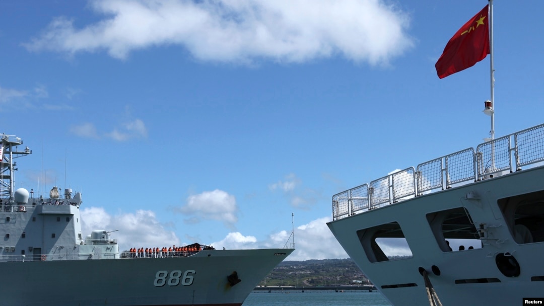 FILE - A Chinese People's Liberation Army (PLA) Navy replenishment ship (L) sails past a PLA Navy hospital ship in a June 24, 2014, photo.