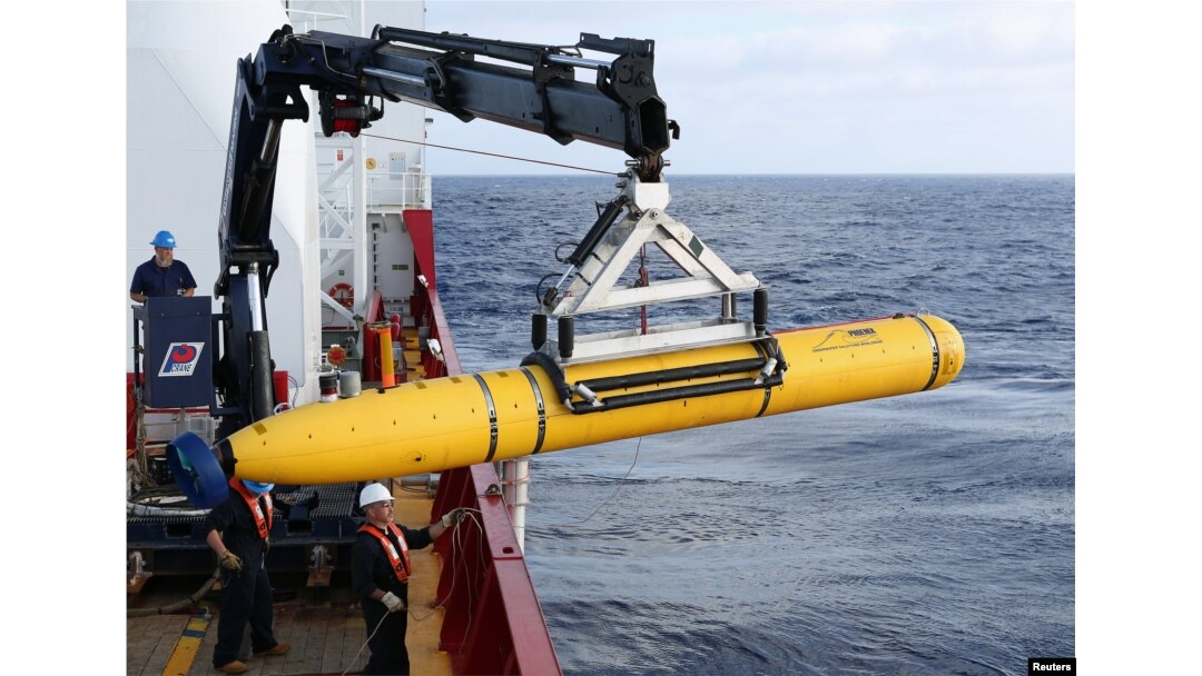 FILE - Crew aboard the Australian Defense Vessel Ocean Shield move the U.S. Navy's Bluefin-21 autonomous underwater vehicle into position for deployment in the southern Indian Ocean to look for the missing Malaysia Airlines flight MH370, April 14, 2014.