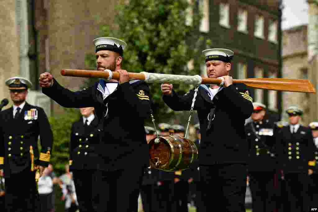 Crew of Britain's HMS Albion carry a keg of wine to the Tower of London during the Constable's Dues ceremony in London. The Constable's Dues ceremony dates back to the fourteenth century when ships travelling up stream to the city were required to moor at Tower Wharf to unload a portion of cargo for the constables as a form of toll.