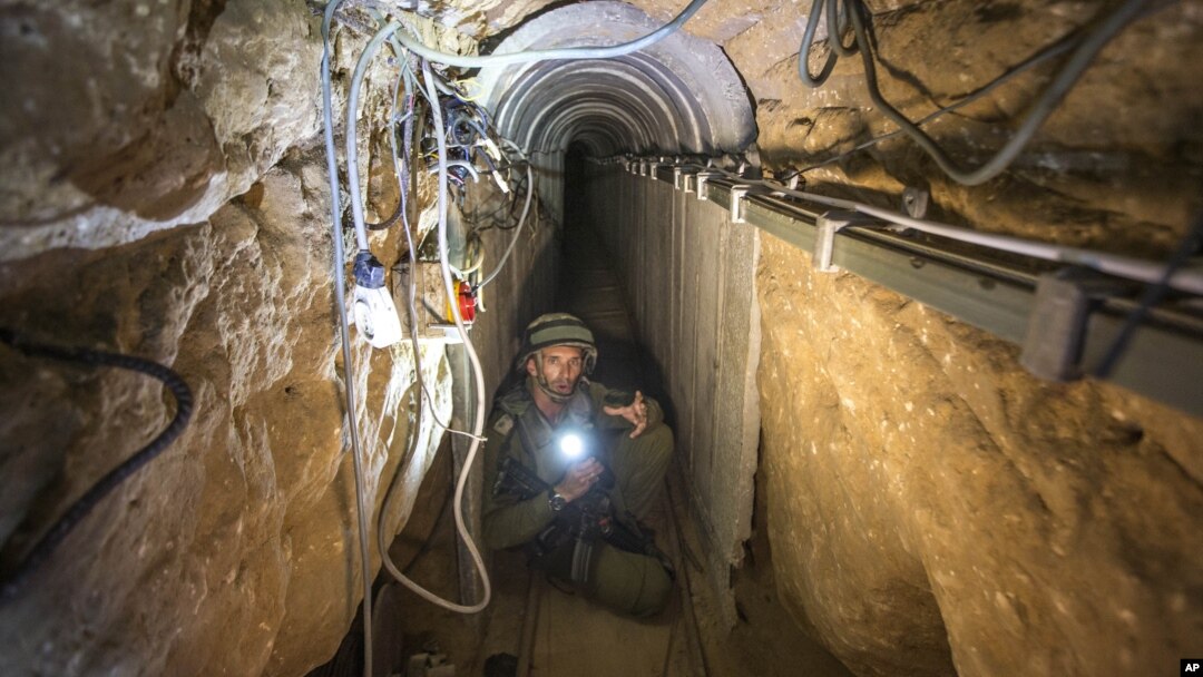 An Israeli army officer shows journalists a tunnel allegedly used by Palestinian militants for cross-border attacks from Gaza into Israel, July 25, 2014.