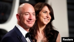 FILE - Amazon's Jeff Bezos and his wife, MacKenzie Bezos, attend the Vanity Fair party in Beverly Hills, Calif., Feb. 26, 2017, after the 89th Academy Awards.