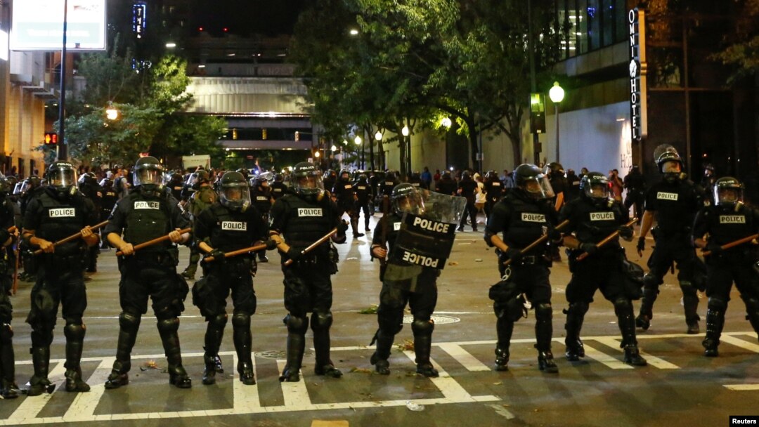 FILE - Police hold their lines in uptown Charlotte during a protest of the police shooting of Keith Scott in Charlotte, North Carolina, Sept. 21, 2016.