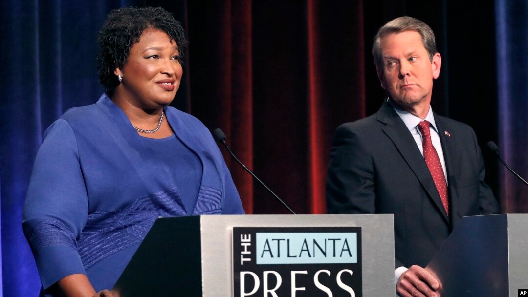 Democratic gubernatorial candidate for Georgia Stacey Abrams, left, speaks as her Republican opponent Secretary of State Brian Kemp looks on during a debate in Atlanta, Oct. 23, 2018.