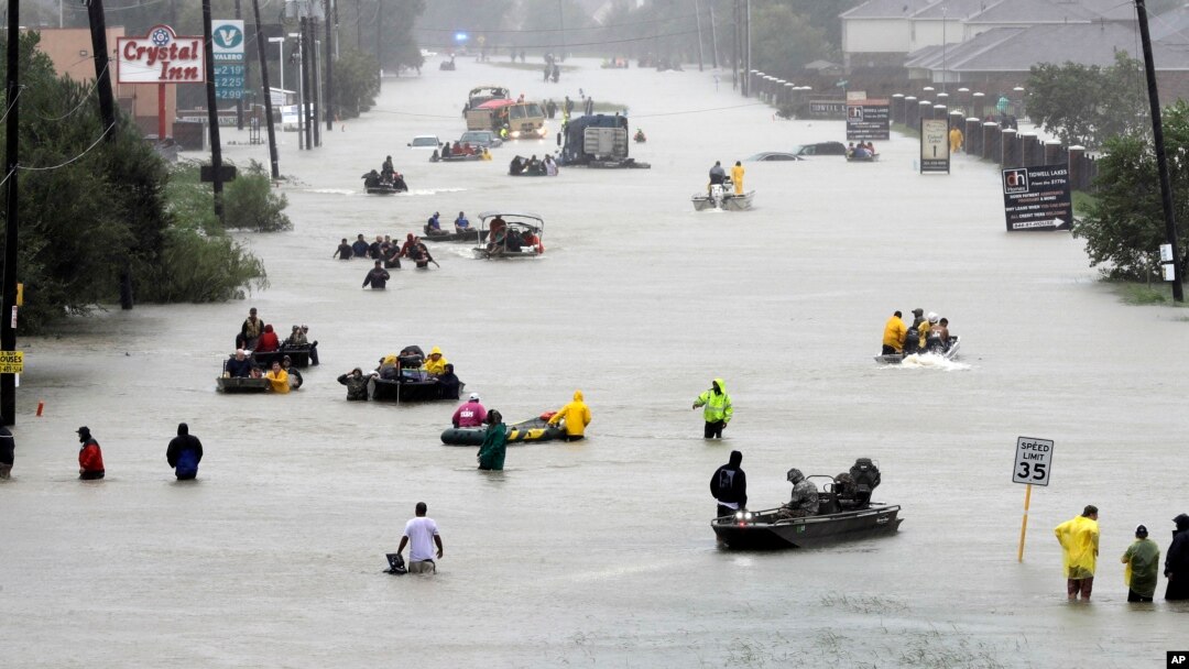 Rescue boats fill a flooded street as flood victims are evacuated as floodwaters from Tropical Storm Harvey rise, Aug. 28, 2017, in Houston, Texas. 