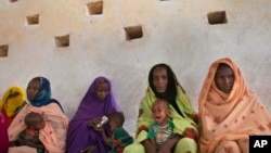 FILE - Mothers wait for their children to be examined for signs of malnutrition at a walk-in nutrition clinic in Barrah, a desert village in the Sahel belt of Chad, April 20, 2012. UNICEF estimates that 127,000 children under five in Chad's Sahel belt wi