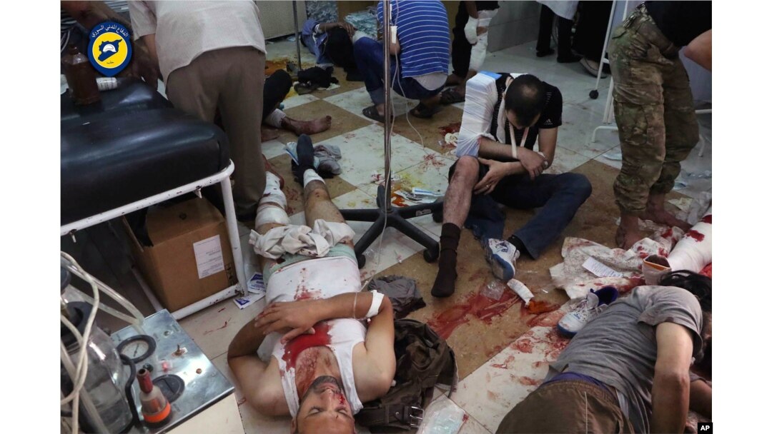 In this photo provided by the Syrian Civil Defense group known as the White Helmets, shows wounded men receiving treatment at a local clinic after airstrikes hit in Aleppo, Syria, Sept. 24, 2016.
