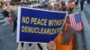 FILE - Protesters march toward the U.S. Embassy during a rally supporting the U.S. policy to put steady pressure on North Korea, in Seoul, South Korea, Nov. 3, 2018. 