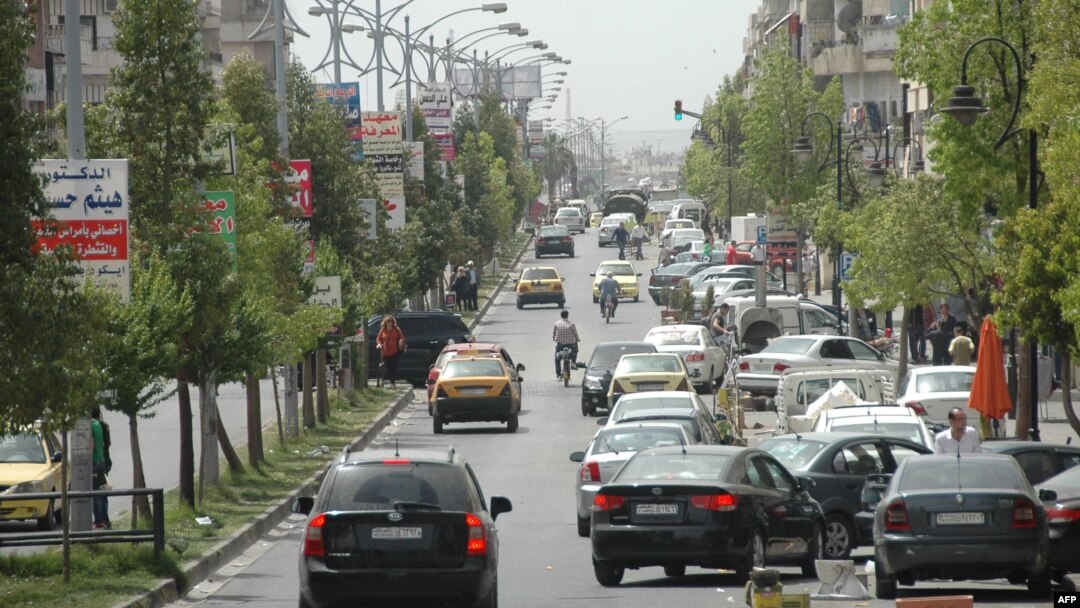 Cars drive on a street in a government-controlled district of Homs, May 7, 2014.