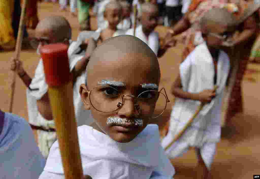 Indian school children dressed like Mahatma Gandhi assemble during an event at a school in Chennai, ahead of Gandhi's birth anniversary.