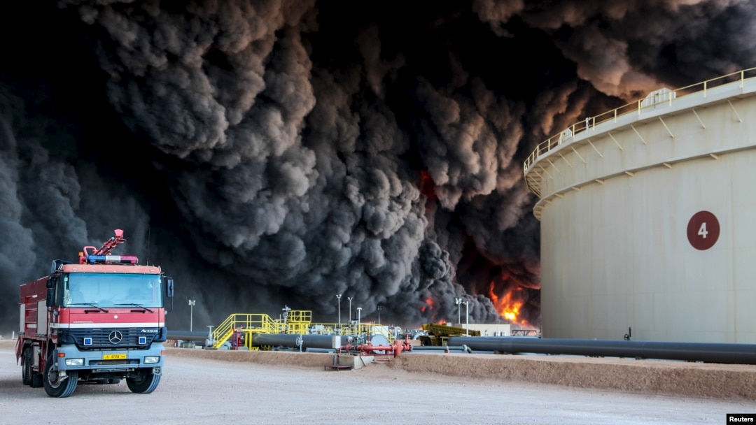 FILE - Fire rises from an oil tank in the port of Es Sider, in Ras Lanuf, Libya, Jan. 6, 2016. A Petroleum Facilities Guards blamed the blazes on attacks by Islamic State militants.