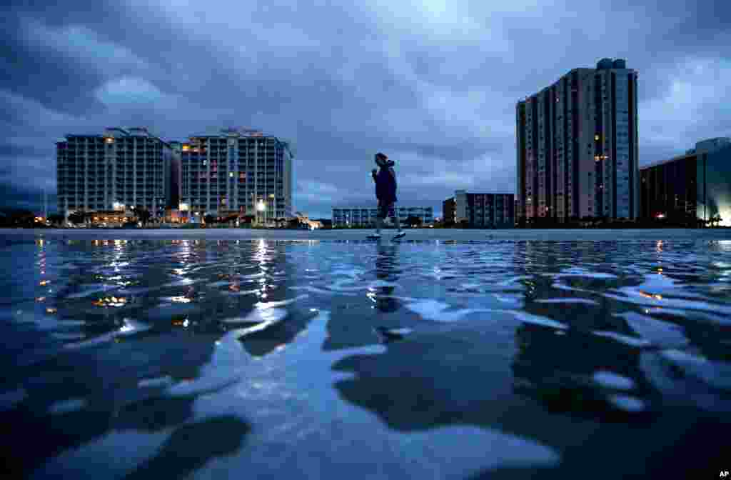 Russ Lewis looks for shells along the beach as Hurricane Florence approaches Myrtle Beach, S.C. "We might get lucky we might not we'll find out," said Lewis of the storm.