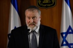Israel's Attorney General Avichai Mandelblit reads a statement in Jerusalem, Nov. 21, 2019. Mandelblit charged PM Benjamin Netanyahu with fraud, breach of trust and accepting bribes in three different scandals.