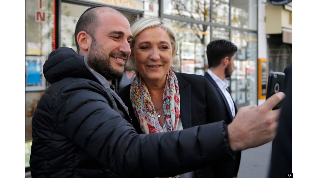 French far-right leader and candidate for the 2017 presidential election Marine Le Pen poses for a selfie after getting a haircut in Paris, April 24, 2017.