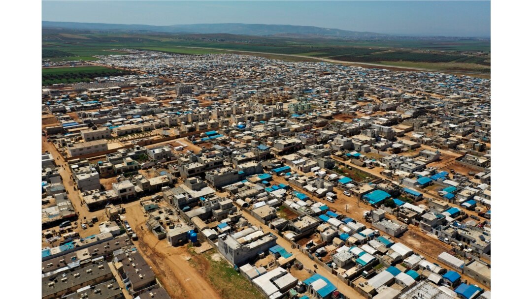This April 19, 2020 photo shows a large refugee camp on the Syrian side of the border with Turkey, near the town of Atma, in Idlib province, Syria.