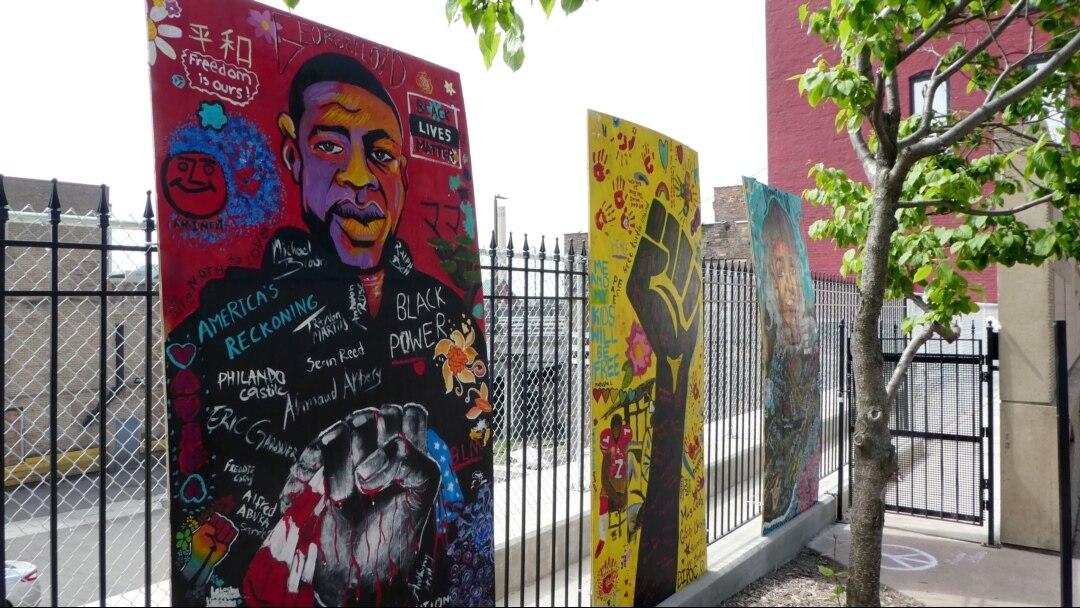Community members painted murals of George Floyd and Breonna Taylor at the Clayton Jackson McGhie Memorial in Duluth, Minnesota. (M. Young/VOA)