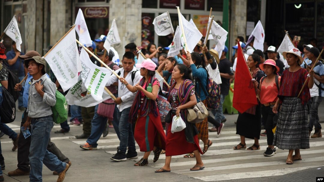 FILE - Hundreds of indigenous people, peasant farmers and activists demonstrate in the streets of Guatemala City, demanding the end of the corruption and the persecution of political leaders, May 8, 2019. 