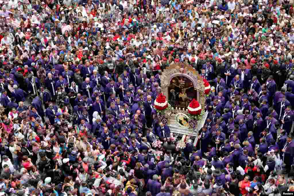 Faithful attend the procession of Senor de Los Milagros (Lord of Miracles), Peru's most revered Catholic religious icon, in Lima, Peru, Oct. 18, 2018.