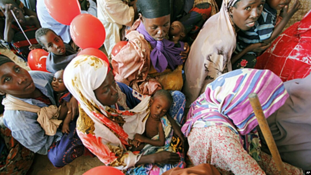Women wait for medical care at Camp Seyidka, a camp for displaced people, in Mogadishu, Somalia, Aug. 19, 2011