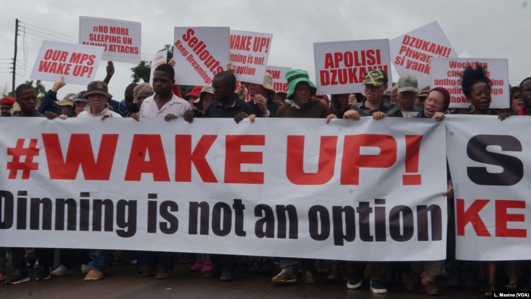 Protesters march in the streets of Malawi's capital, Lilongwe, over continued attacks on albinos.